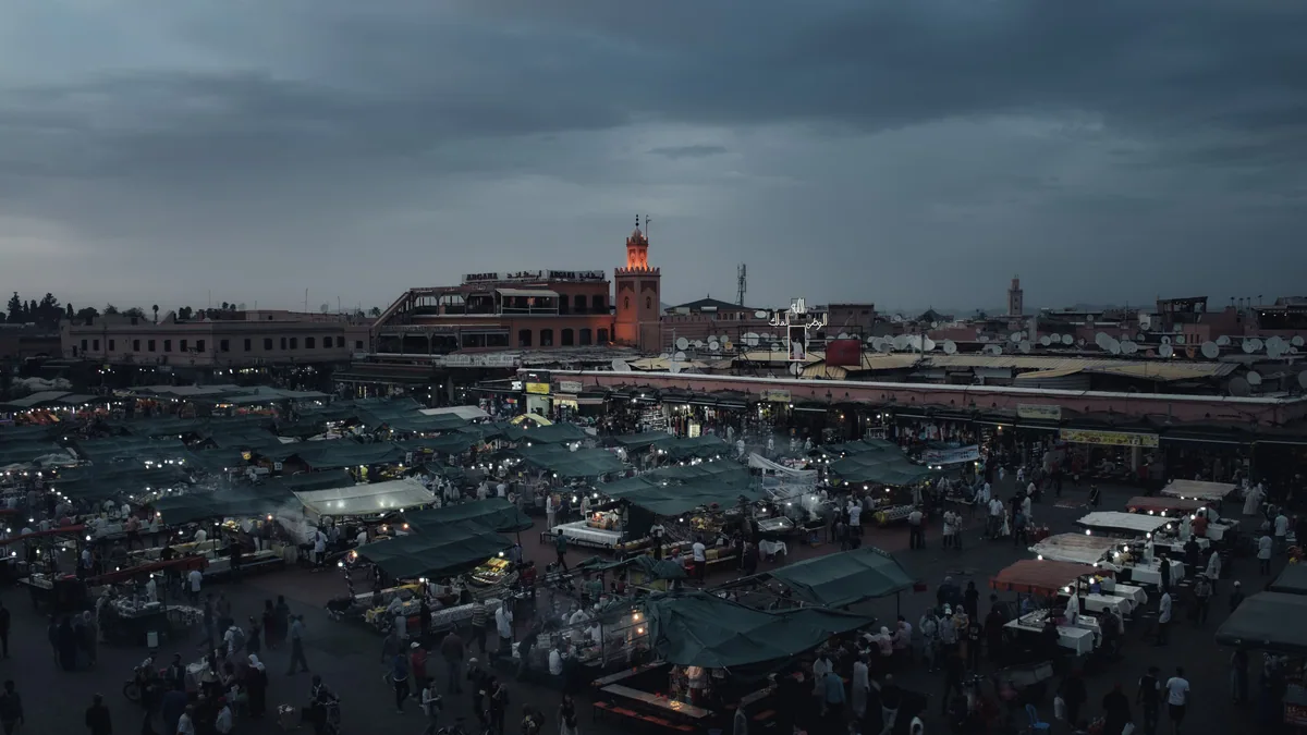Traveller checking maps on the best eSIM Morocco data plan at Jemaa el-Fnaa in Marrakech